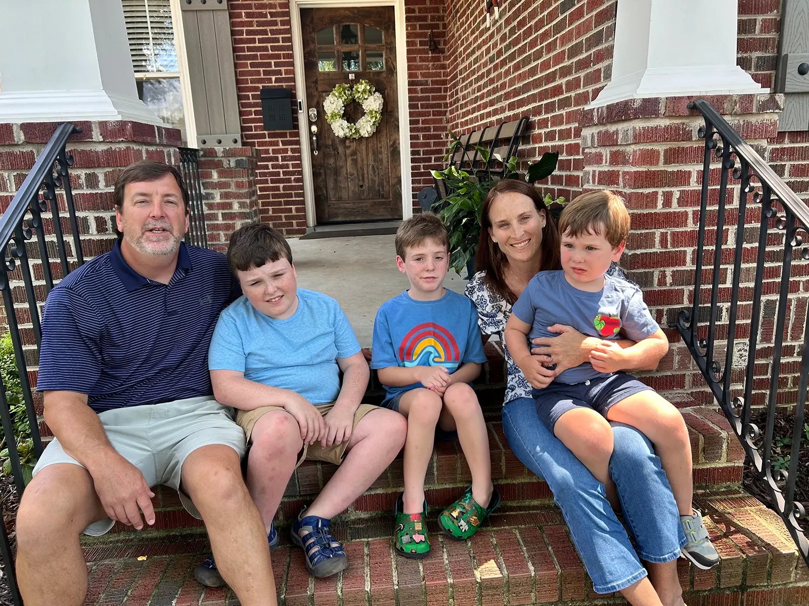 The Wells Family sits on their porch